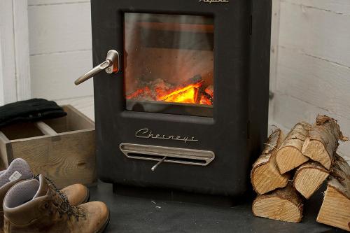 a stove with a fire inside of it at Laggan Bothies in Spean Bridge
