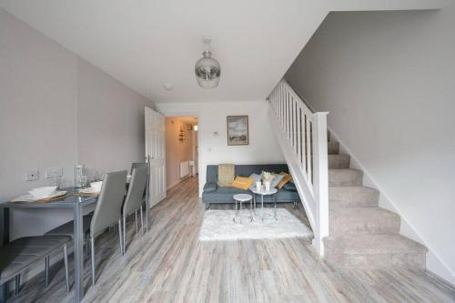 a living room with a staircase with a couch and a table at Stylish 2-bed home - For Company contractor and Leisure stays - NEC, Airport, HS2, Contractors, Resort World in Birmingham