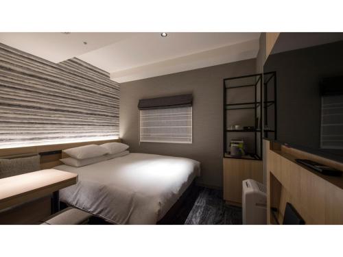 a bedroom with a white bed and a window at Tmark City Hotel Kanazawa - Vacation STAY 90378v in Kanazawa