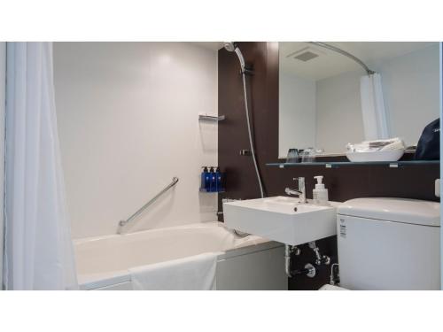 a bathroom with a sink and a tub and a toilet at Tmark City Hotel Kanazawa - Vacation STAY 90378v in Kanazawa
