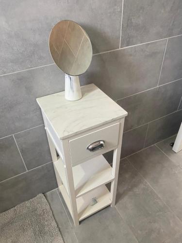 a white nightstand with a mirror on top of it at Belle Luxury Apartments in Gros Islet