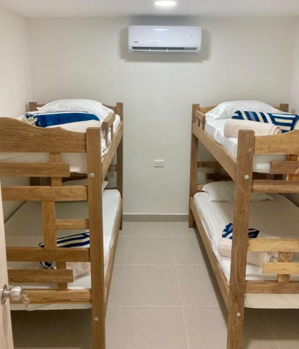 two bunk beds in a room with a air conditioner at Casa Sonia in Cartagena de Indias