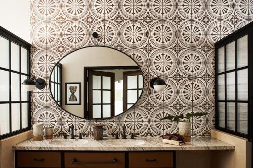 a bathroom with a large mirror on a wall at Hotel Figueroa, Unbound Collection by Hyatt in Los Angeles