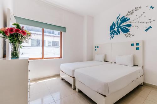Postel nebo postele na pokoji v ubytování Loft Hotel Malecón Vallarta