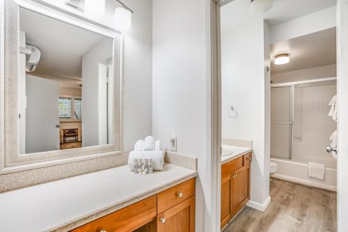 a bathroom with a sink and a mirror at Pono Kai Resort in Kapaa