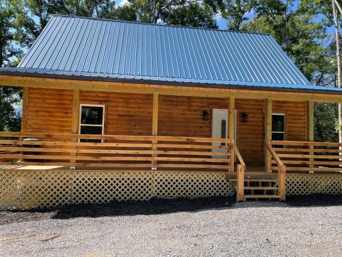 a large wooden cabin with a blue roof at windrock ridge - Ethan in Oak Ridge