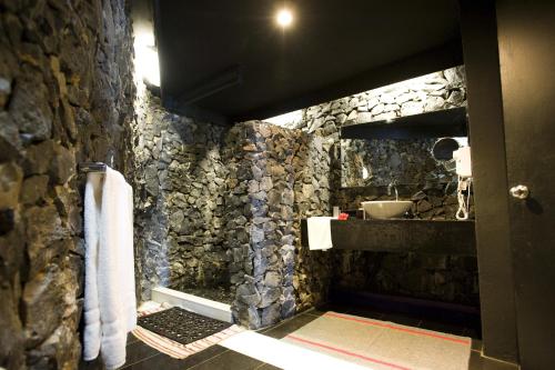 a stone walled bathroom with a sink and towels at Stevensons at Manase in Manase