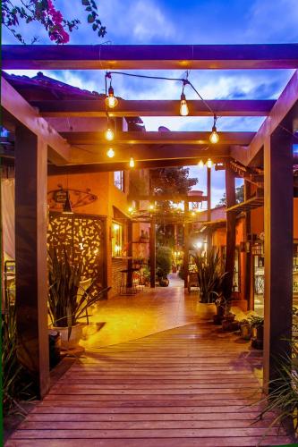 a covered walkway in a building with lights at Pousada Alecrim do Campo in Sao Jorge