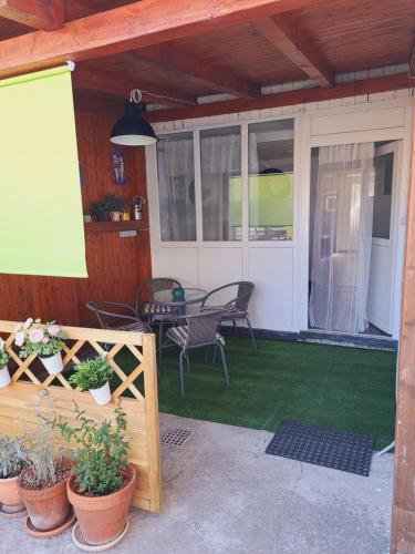 a patio with chairs and a table and some plants at Apartman Megolina in Varaždin