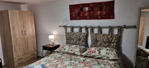 a bedroom with a bed with a colorful comforter at SEGESTA - Le Bouquet in Salemi