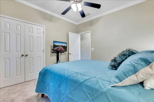 a bedroom with a blue bed and a ceiling fan at Atlanta Private Charming Room 3 in Atlanta