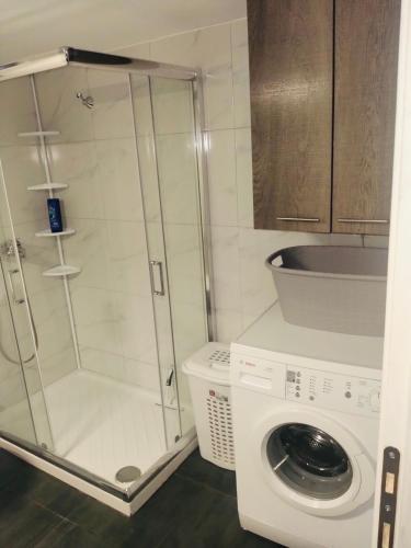 a bathroom with a washing machine and a washer at Soners Dream Apartment in Drama