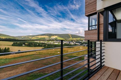 a house with a balcony with a view at Enzian by Mountain ways in Loučná pod Klínovcem