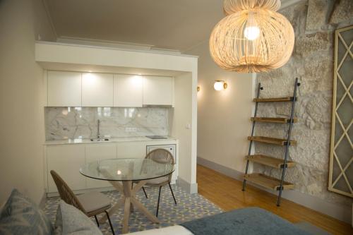 a kitchen with a glass table and chairs in a room at TOP Porto in Porto