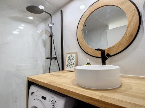 a bathroom with a sink and a mirror at La Pitcholine : Superbe studio au Vieux-Port in Marseille