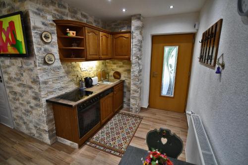 a kitchen with a sink and a stove top oven at APARTMENTS V+K in Tatranska Strba