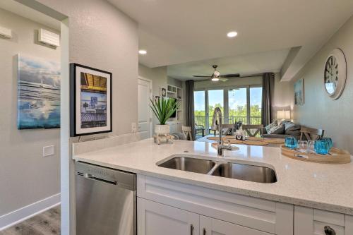 a kitchen with a sink and a living room at Coastal-Zen Ruskin Retreat Less Than 1 Mi to Beach! in Ruskin
