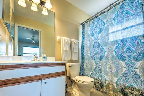 a bathroom with a toilet and a sink and a shower at Cozy Sebring Condo with Screened Porch and Grill! in Sebring