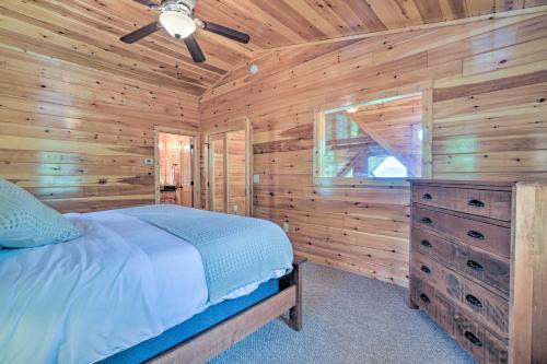 a log cabin bedroom with a bed and a dresser at Hiwassee Hideaway Cabin with Mountain Views! in Turtletown