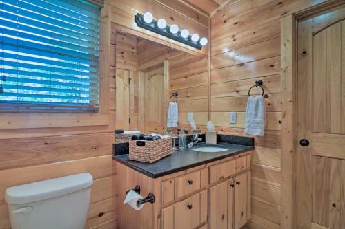 a bathroom with a toilet and a sink at Hiwassee Hideaway Cabin with Mountain Views! in Turtletown