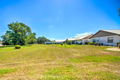 a large yard with houses in the background at Screened Porch and Pool Access Cozy Sebring Condo in Sebring