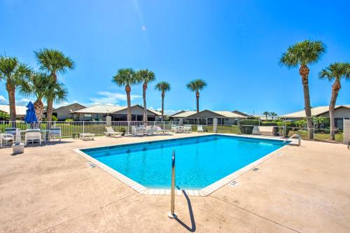 a swimming pool at a resort with palm trees at Screened Porch and Pool Access Cozy Sebring Condo in Sebring
