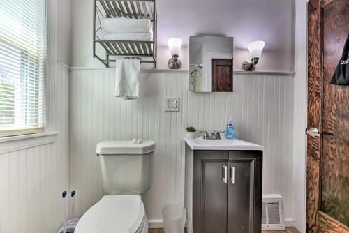 a bathroom with a toilet and a sink at Orchard Park Home Less Than 2 Mi to Highmark Stadium! in Orchard Park