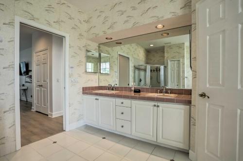 a bathroom with two sinks and a large mirror at Private Pool and Hot Tub Port St Lucie Escape in Port Saint Lucie