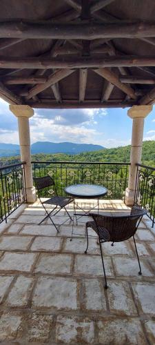 a table and chairs on a patio with a view at Soul boutique hotel in Monodendri