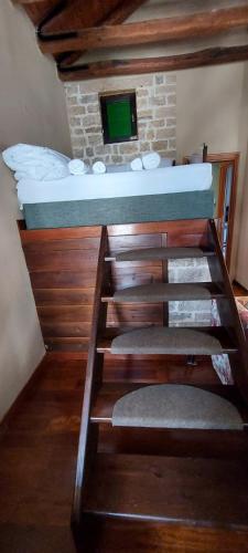 a bunk bed in a room with a fireplace at Soul boutique hotel in Monodendri