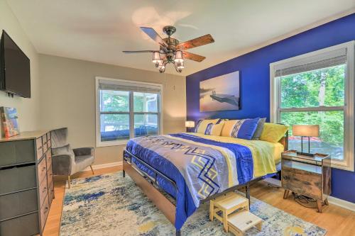 a bedroom with a bed and a ceiling fan at Lakefront Eatonton Getaway with Dock and Grill! in Resseaus Crossroads