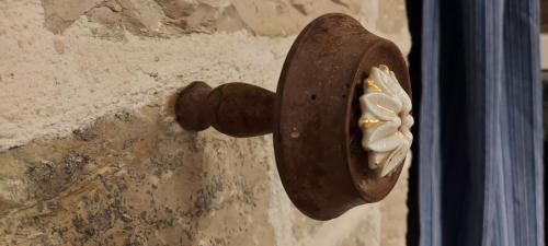 a wooden door knocker on a stone wall at Soul boutique hotel in Monodendri