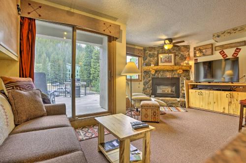 a living room with a couch and a fireplace at Ski-InandSki-Out Studio at Winter Park Base! in Winter Park
