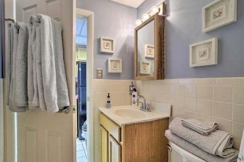 a bathroom with a sink and a mirror at Quaint Wildwood Condo about Walk to Beach! in Wildwood