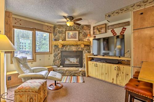 a living room with a fireplace and a tv at Ski-InandSki-Out Studio at Winter Park Base! in Winter Park