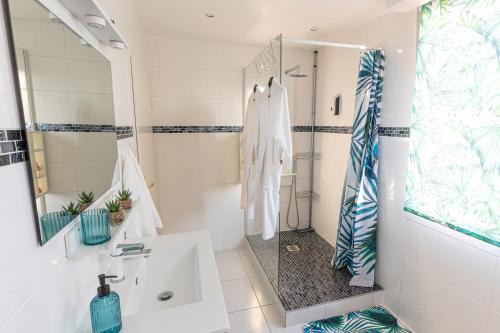 a white bathroom with a sink and a shower at Dynasty Home Spa Appartement 100M Jacuzzi Terasse in Holtzheim