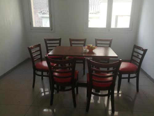 a dining room with a wooden table and chairs at hostal mancora monjitas 755 in Santiago