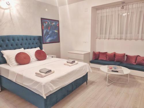a bedroom with a large bed and a couch at Apartments Golden Bridge in Mostar