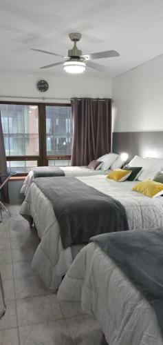 a bedroom with two beds and a ceiling at CORAZOn BUENOs AIREs PLATINo in Buenos Aires
