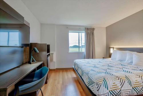 a hotel room with a bed and a television at Motel 6-Denison, TX in Denison