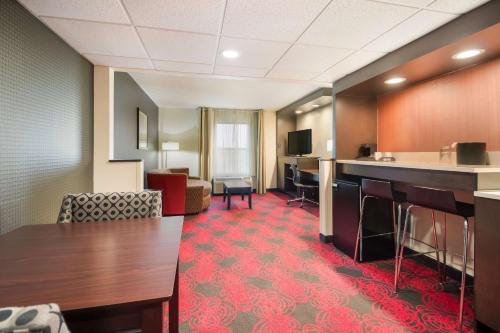 a hotel room with a bar and a living room at Best Western Suites near Opryland in Nashville