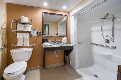 a bathroom with a toilet a sink and a bathtub at Best Western Suites near Opryland in Nashville