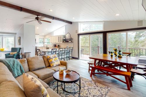 a living room with a couch and a table at Tahoe Paradise Chalet in South Lake Tahoe
