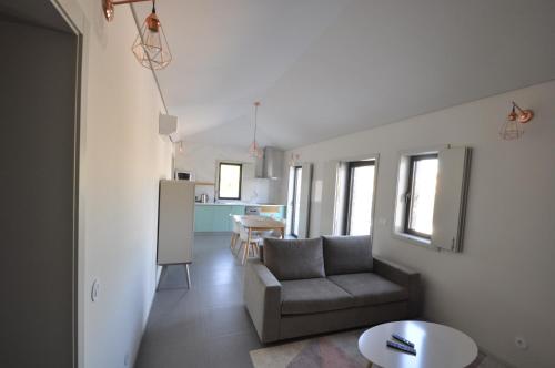 a living room with a couch and a kitchen at Olival da Seara in Marco de Canaveses