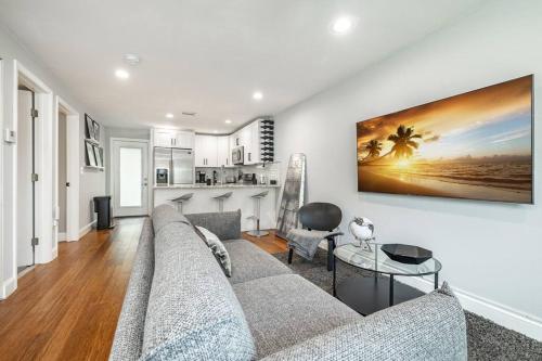 a living room with a couch and a table at Grand Oaks Terminal in the Heights in Tampa