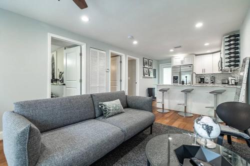 a living room with a couch and a kitchen at Grand Oaks Terminal in the Heights in Tampa