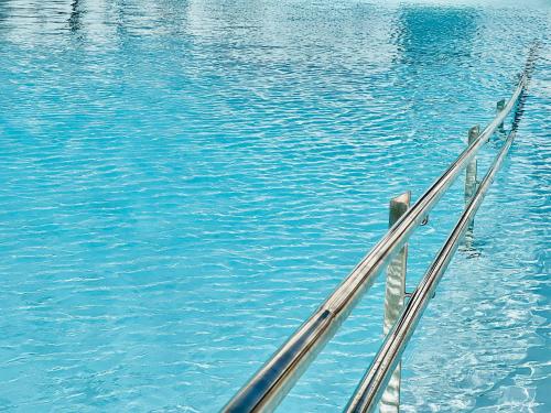 a view of a body of water with a metal railing at Canaryislandshost l Las Olas in Costa Teguise