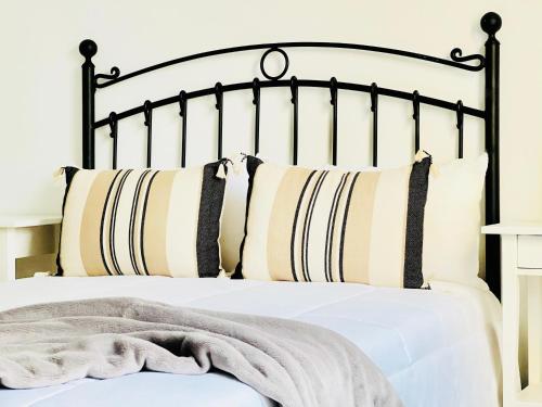 a bed with black and white pillows at Canaryislandshost l Las Olas in Costa Teguise