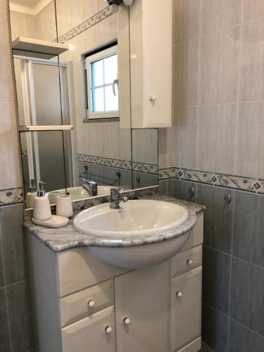 a bathroom with a sink and a mirror at Monte das Hortas Velhas in Viana do Alentejo