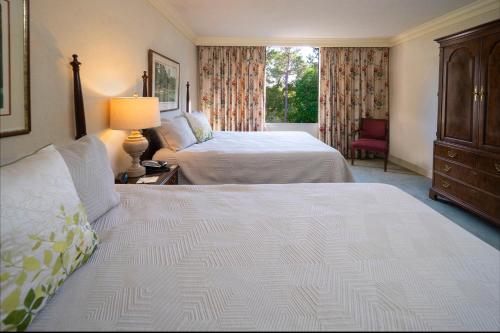 a hotel room with two beds and a window at The Inn at Houndslake in Aiken